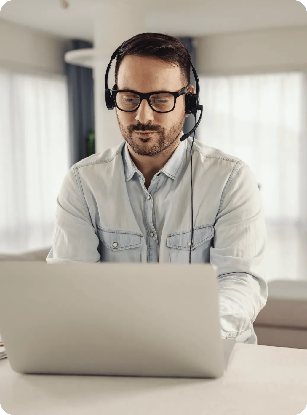A male call center agent working on his laptop