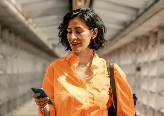 A woman sending an SMS from her mobile phone