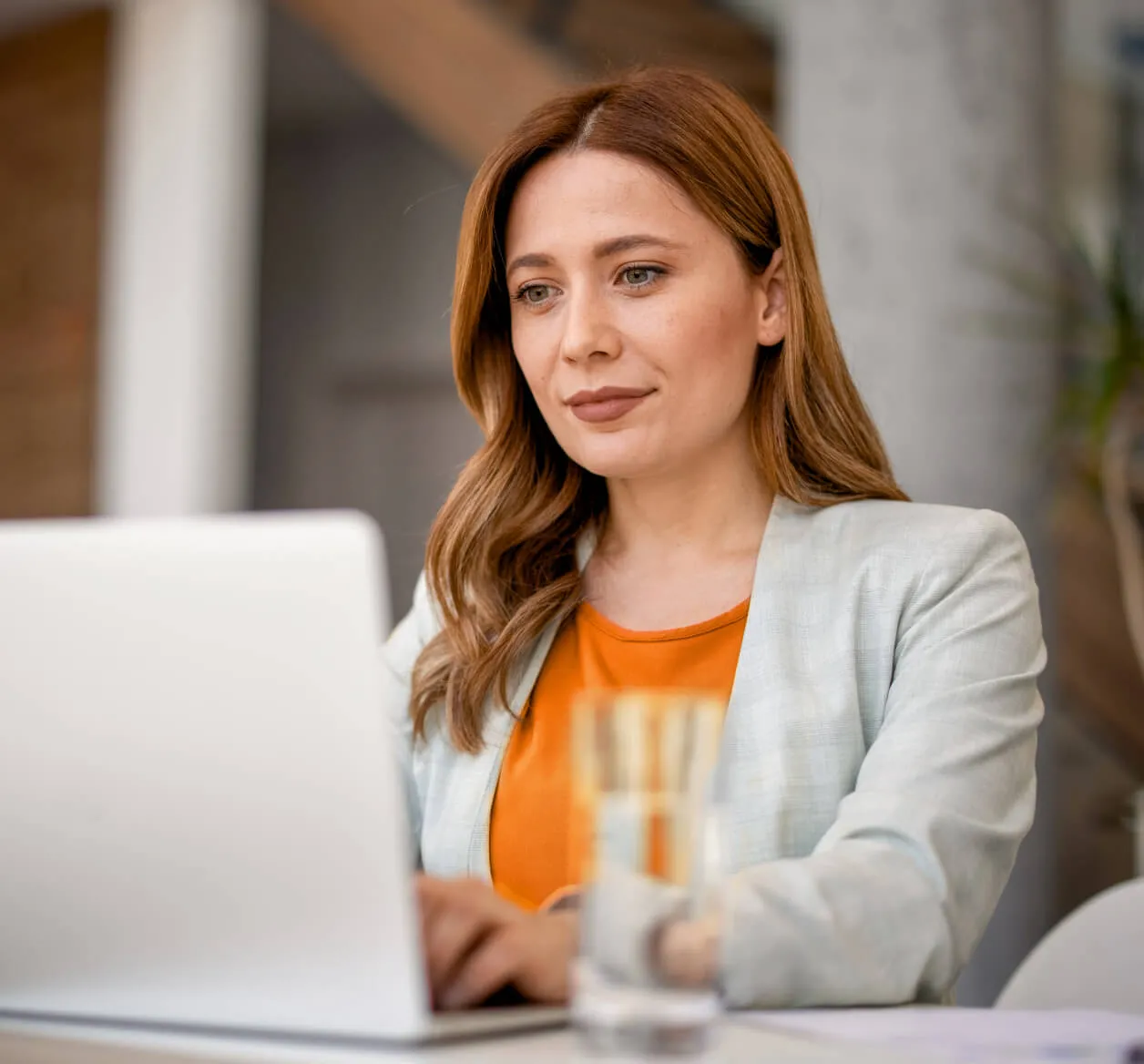 A woman looking at the RingCentral Advocate Program on her laptop.