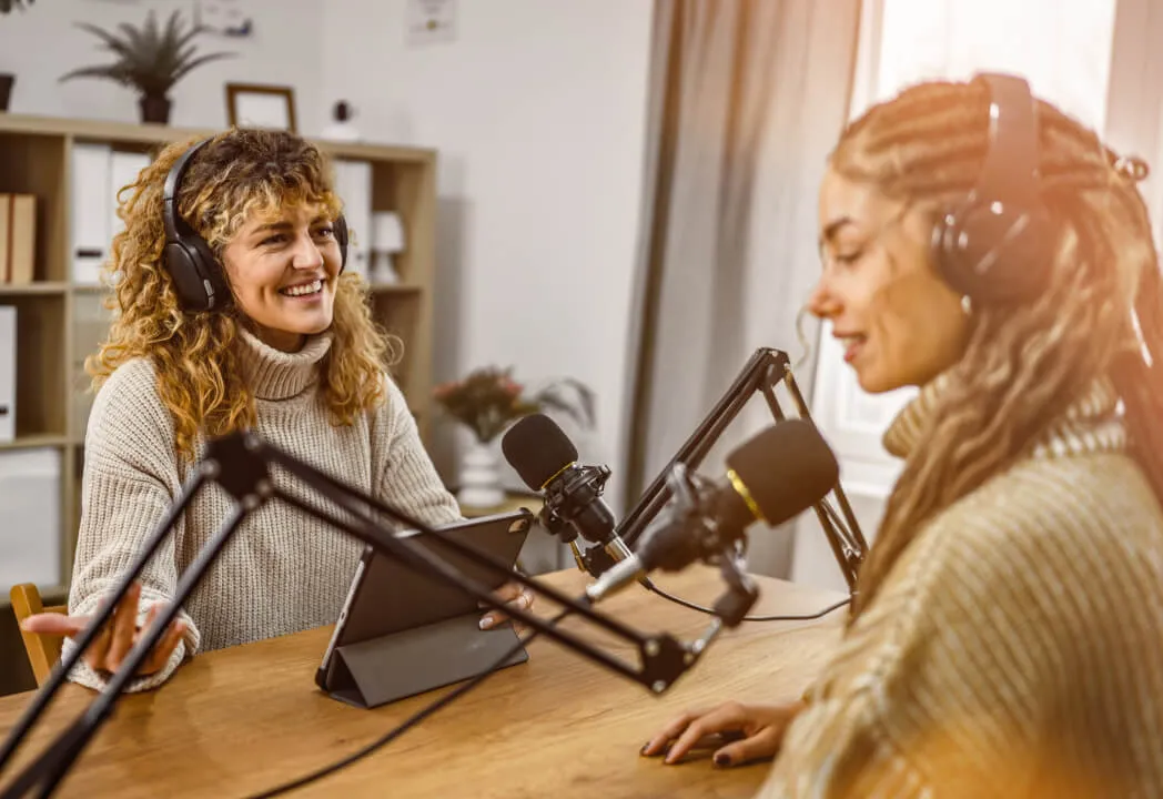 Two event hosts smile as they speak during a RingCentral webinar